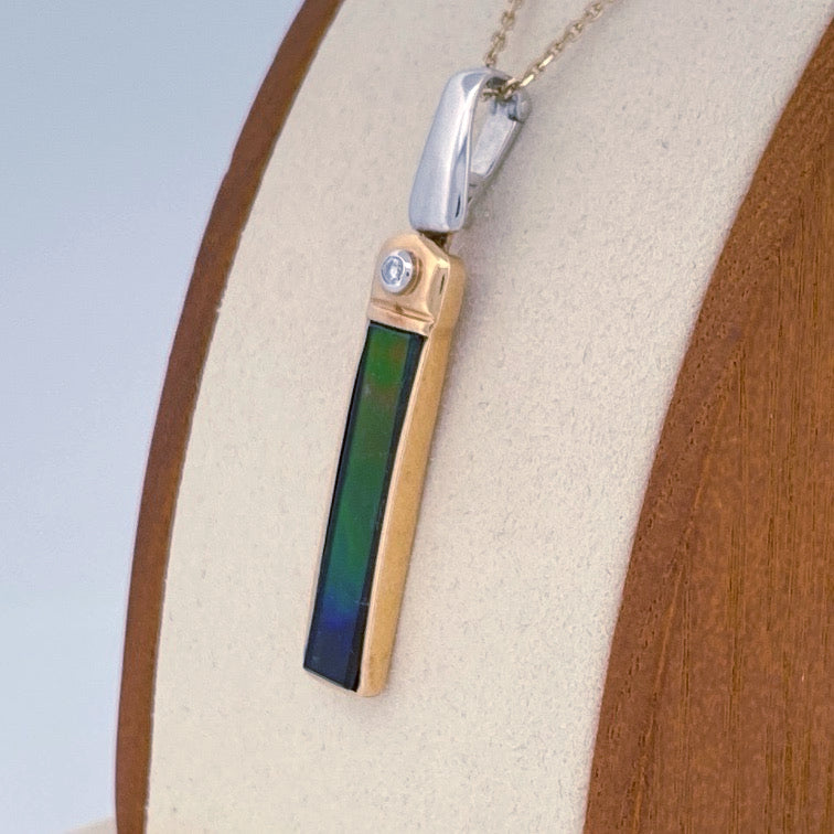 Unveiling a Gemstone Wonder: 18k Two-Tone Ammolite & Diamond Pendant (On Consignment)