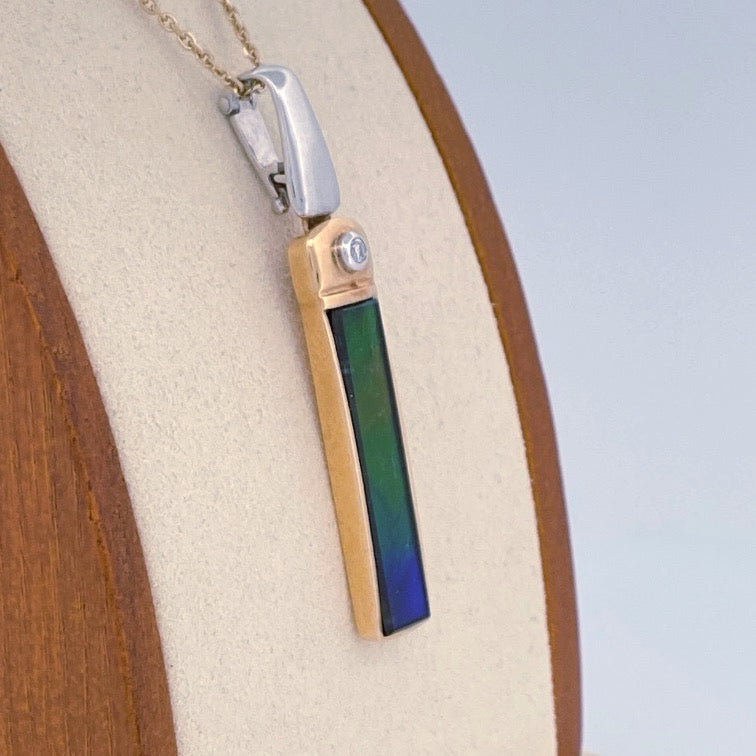 Unveiling a Gemstone Wonder: 18k Two-Tone Ammolite & Diamond Pendant (On Consignment)