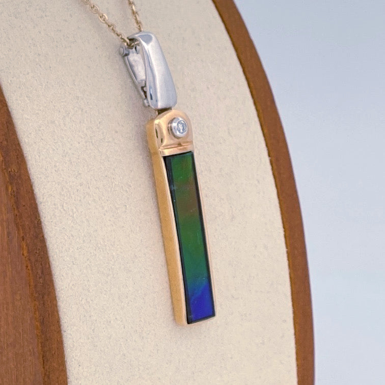 Unveiling a Gemstone Wonder: 18k Two-Tone Ammolite & Diamond Pendant (On Consignment)