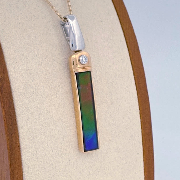 Unveiling a Gemstone Wonder: 18k Two-Tone Ammolite & Diamond Pendant (On Consignment)