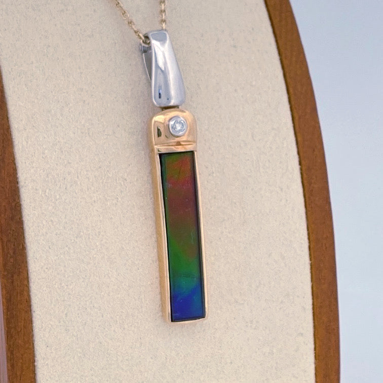 Unveiling a Gemstone Wonder: 18k Two-Tone Ammolite & Diamond Pendant (On Consignment)