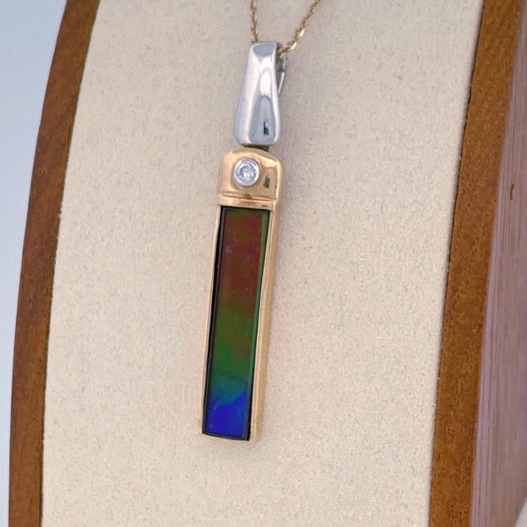 Unveiling a Gemstone Wonder: 18k Two-Tone Ammolite & Diamond Pendant (On Consignment)